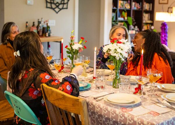 Guests at AJC reporter Olivia Wakim's recent Galentine's Day supper club event included, among others, Hi-Five Supper Club co-owners Kristin “Naki” Nakama (foreground) and Liz Peña (center right), AJC food and dining editor Ligaya Figueras (far left) and Access Atlanta entertainment reporter Vicky Ro (far right). (Aaliyah Man for The Atlanta Journal-Constitution) 