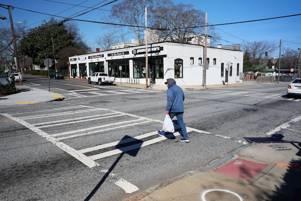 A pedestrian cautiously crosses Boulevard SE at the intersection with Woodward Avenue on Feb. 21 in Atlanta. This intersection is one of a several slated for upgrades under infrastructure bond program projects. (Jason Getz/AJC)