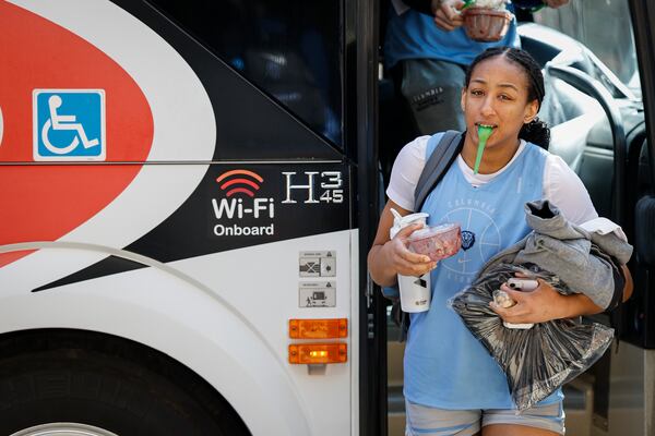 Columbia forward Perri Page leaves the team bus with her hands full in Chapel Hill, N.C., Wednesday, March 19, 2025, before their First Four basketball game in the NCAA Tournament against Washington on March 20. (AP Photo/Nell Redmond)