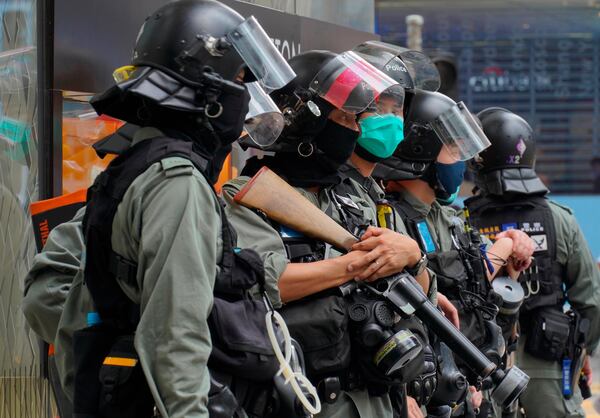 Riot Police stand guard at Central during the second day of debate on a bill that would criminalize insulting or abusing the Chinese anthem in Hong Kong.