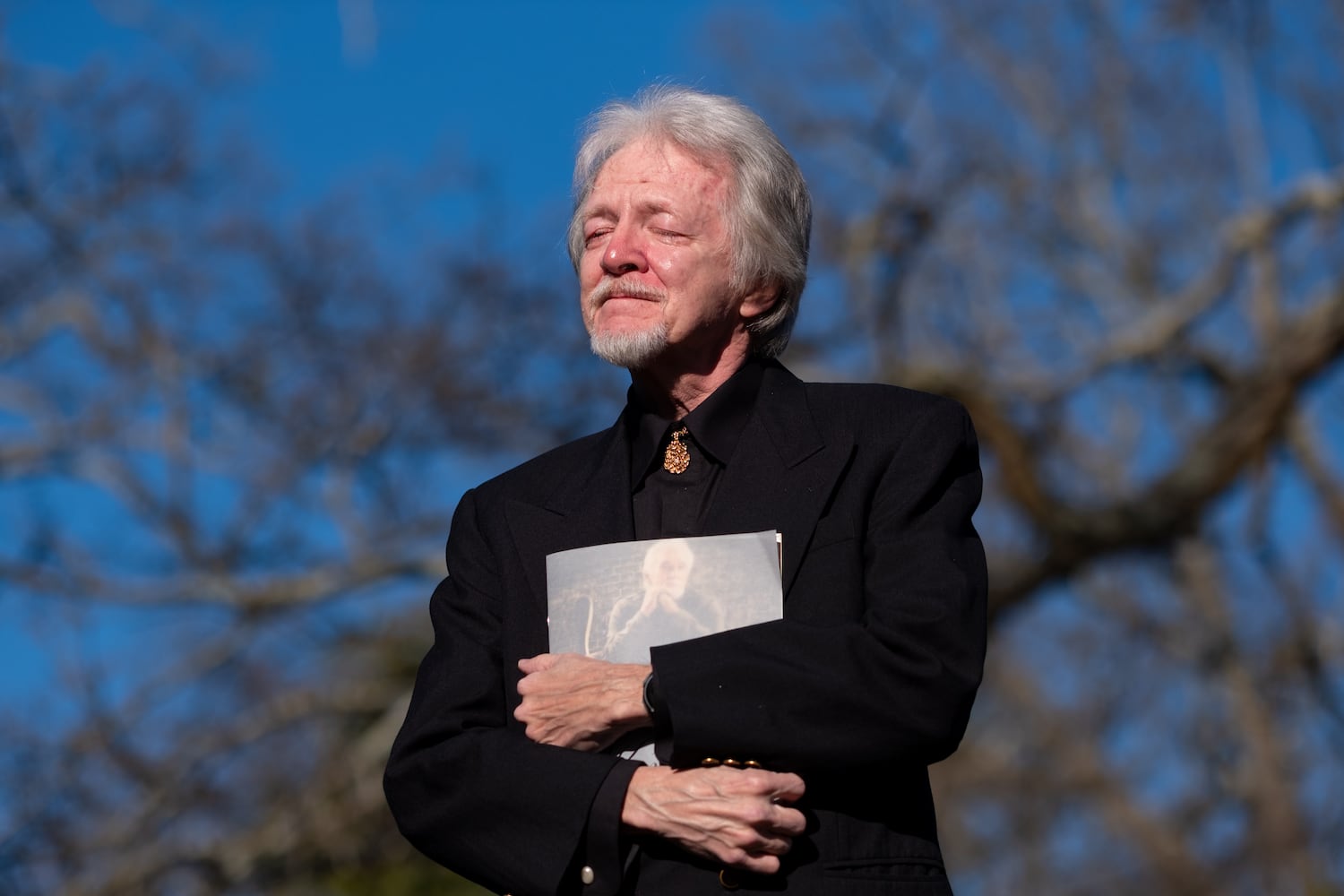 Gene Sisk, longtime keyboardist for Kenny Rogers, sheds a tear and clutches a program during a memorial service for the country legend at Oakland Cemetery on Sunday, Mar. 20, 2022. Rogers died Mar. 20, 2020, but the memorial service was postponed for two years due to the Covid-19 pandemic.  Ben Gray for the Atlanta Journal-Constitution