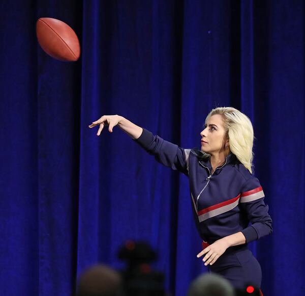  Lady Gaga throws her official game ball to her dad, Joe, at the Super Bowl LI halftime show press conference on Thursday, Feb. 2, 2017, in Houston, Texas. (Curtis Compton/Atlanta Journal-Constitution/TNS)