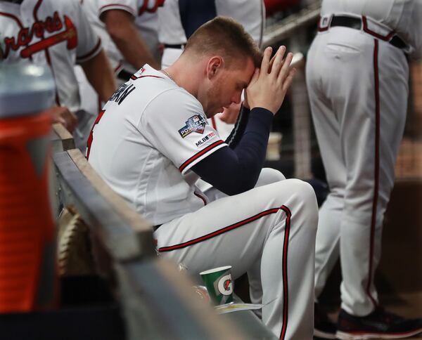 Braves first baseman Freddie Freeman sits dejected in the dugout in the 9th inning as the Braves are eliminated falling 13-1 to the St. Louis Cardinals in game 5 of the NLDS Wednesday, Oct. , 9, 2019, at SunTrust Park in Atlanta.    