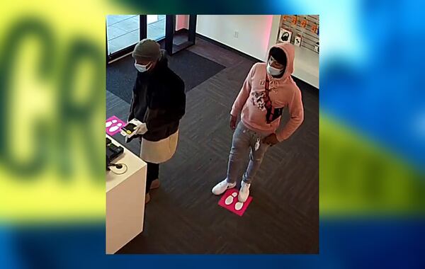 Two armed robbery suspects were caught on camera taking cellphones from a T-Mobile store on Wesley Chapel Road in Decatur.