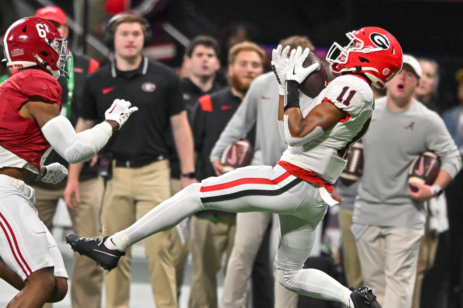 Georgia Bulldogs wide receiver Arian Smith (11) makes a catch over Alabama Crimson Tide defensive back Jaylen Key (6) during the second half of the SEC Championship football game at the Mercedes-Benz Stadium in Atlanta, on Saturday, December 2, 2023. (Hyosub Shin / Hyosub.Shin@ajc.com)