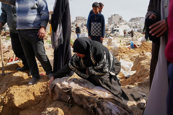 The bodies of Palestinians killed during the Israel-Hamas war and were buried in a mass grave at Shifa Hospital yard are exhumed for identification and reburial in Gaza City's official cemeteries, on Thursday, March 13, 2025. (AP Photo/Abdel Kareem Hana)