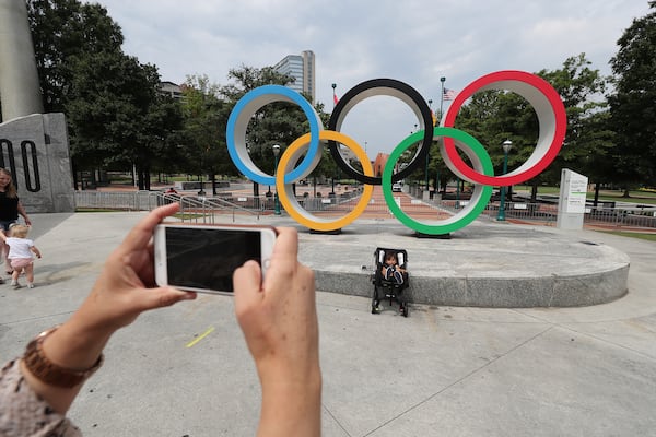 A visitor snaps a photo of the renovated Olympic rings at Centennial Olympic Park on August 2, 2021. Curtis Compton / Curtis.Compton@ajc.com