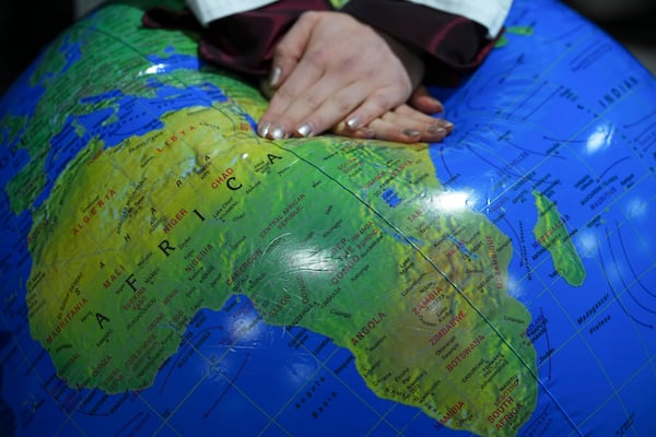 FILE - Ann Carlotta Oltmanns pretends to resuscitate the Earth during a demonstration at the COP29 U.N. Climate Summit, Nov. 18, 2024, in Baku, Azerbaijan. (AP Photo/Peter Dejong, File)