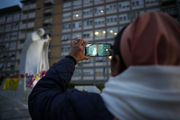 A nun takes photos in front of the Agostino Gemelli Polyclinic, in Rome, Saturday, March 8, 2025, where Pope Francis is hospitalized since Friday, Feb. 14. (AP Photo/Andrew Medichini)