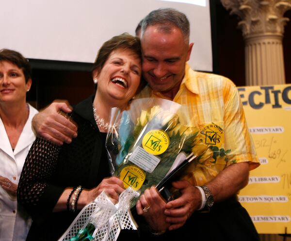 Bev Wingate, the unofficial "mother" of the City of Dunwoody, was presented flowers and gets a hug from Bob Dallas, a Planning Commission member, after it was clear the Dunwoody cityhood referendum would pass in July 2008. (Photo: Bob Andres / bandres@ajc.com)