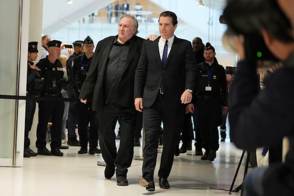 Actor Gerard Depardieu, left, arrives at his trial for the alleged sexual assaults of two women on a film set in 2021, with his lawyer Jeremie Assous ,Tuesday, March 25, 2025 in Paris. (AP Photo/Aurelien Morissard)