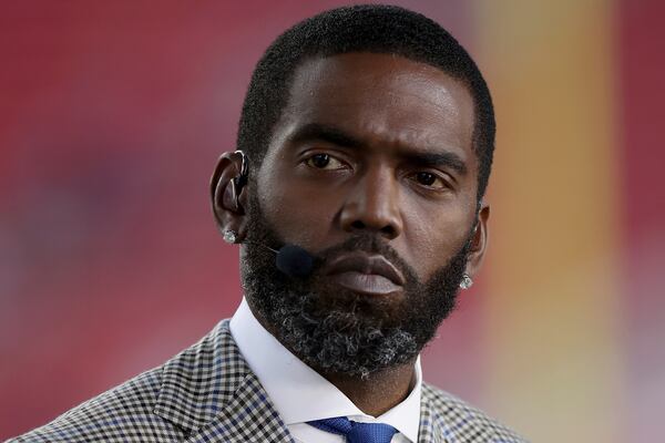 FILE Broadcaster Randy Moss sits on the sideline before an NFL football game between the San Francisco 49ers and the Los Angeles Rams, Monday, Nov. 15, 2021, in Santa Clara, Calif. (AP Photo/Scot Tucker, File)