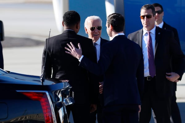 President Joe Biden speaks with U.S. Sen Jon Ossoff and Atlanta Mayor Andre Dickens as he arrives at Hartsfield-Jackson International Airport before delivering a sermon at Ebenezer Baptist Church on Sunday, January 15, 2023. (Photo: Miguel Martinez / miguel.martinezjimenez@ajc.com)