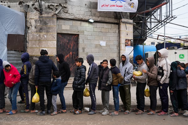 Palestinians queue to purchase bread outside a bakery in Gaza City, Monday, Feb. 24, 2025. (AP Photo/Abdel Kareem Hana)