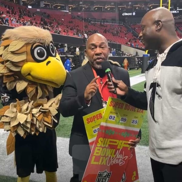 Carver High School football coach Darren Myles talks to the crowd at a recent Falcons game after being named the team's coach of the year.