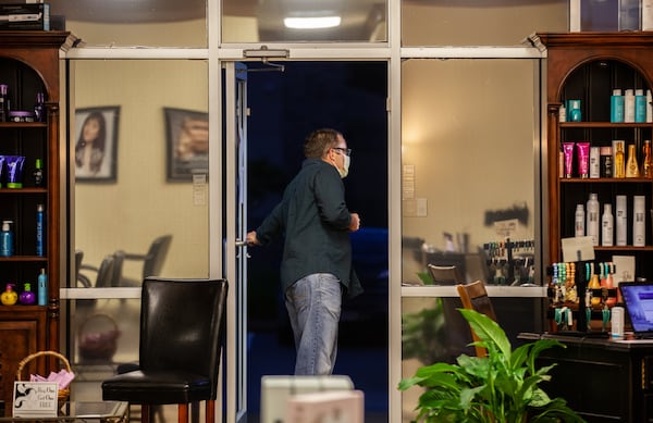 Stephen Richardson looks out for first customer of the day at Studio 151, Friday, April 24, 2020 in Dallas, Ga. Studio 151 is one of many businesses allowed to reopen after Gov. Kemp announced certain facilities can reopen to relieve strain on Georgia's economy.  BRANDEN CAMP/SPECIAL