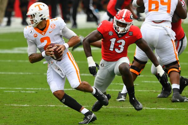 Georgia linebacker Azeez Ojulari (13) chases Tennessee quarterback Jarrett Guarantano (2) during the first half of a football game Saturday, Oct. 10, 2020, at Sanford Stadium in Athens. JOHN AMIS FOR THE ATLANTA JOURNAL- CONSTITUTION