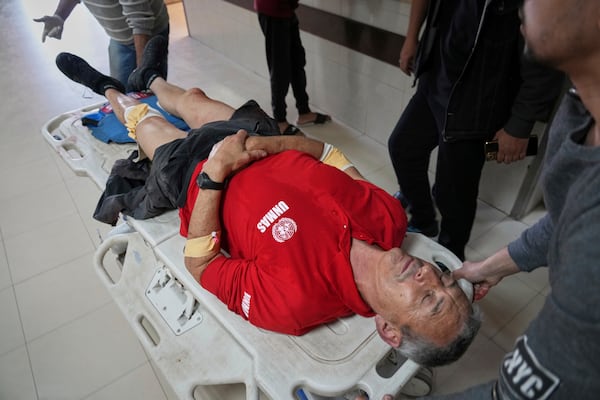 An injured United Nations Mine Action Service (UNMAS) worker is taken into the al-Aqsa Martyrs hospital after an explosion in Deir al-Balah in central Gaza, Wednesday March 19, 2025.(AP Photo/Abdel Kareem Hana)