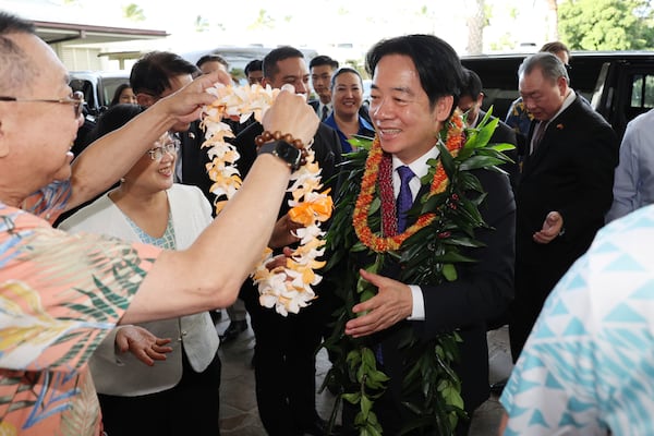 Taiwan President Lai Ching-te, right, receives a flower lei from members of the Taiwanese American community at the Kahala Hotel and Resort Saturday, Nov. 30, 2024 in Honolulu. (AP Photo/Marco Garcia)