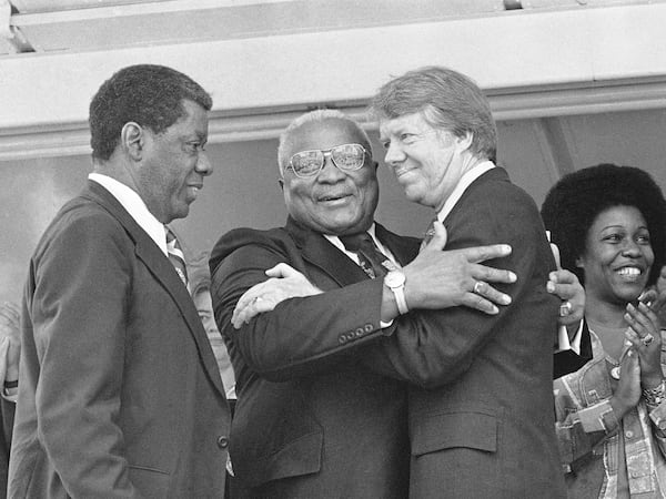 The Rev. Dr. Martin Luther King Sr., center, and Democratic presidential hopeful Jimmy Carter, right, embrace during a campaign rally where King declared, "I love and believe in him,"; April 13, 1976, in Atlanta, Ga. 

In a prepared speech read by Atlanta businessman Jesse Hill, left, King said Carter has been for equal justice when it wasn't an easy thing to be for in South Georgia. Carter has been under sharp criticism from some Black leaders since his statement on ethnic purity. (AP Photo)