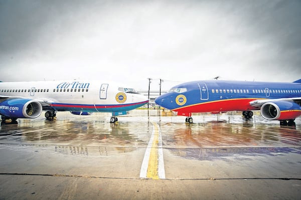 Southwest and AirTran jets shown parked nose to nose after the announcement of the carriers' merger. Southwest Airlines