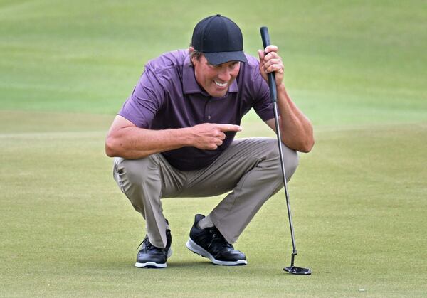 Stephen Ames smiles as he lines up a putts with his son and caddy Ryan Ames (not pictured) on the ninth green during the first round of the Mitsubishi Electric Classic at TPC Sugarloaf, Friday, May 5, 2023, in Duluth. (Hyosub Shin / Hyosub.Shin@ajc.com)