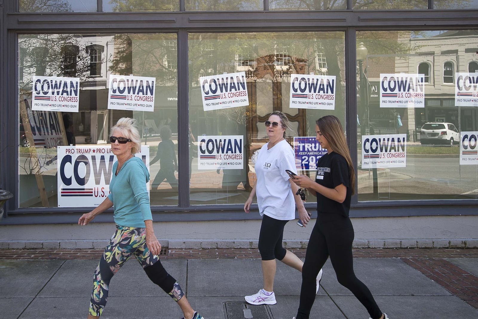 Signs promoting Dr. John Cowan’s campaign in the 14th Congressional District’s GOP primary are plastered in the window of a business on Broad Street in historic downtown Rome. Cowan is facing Marjorie Taylor Greene in the Aug. 11 runoff. (ALYSSA POINTER / ALYSSA.POINTER@AJC.COM)