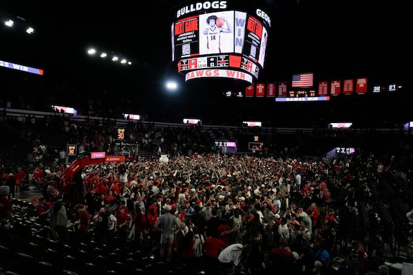 Georgia fans rush the court in celebration after an NCAA college basketball game against Florida, Tuesday, Feb. 25, 2025, in Athens, Ga. (AP Photo/Brynn Anderson)