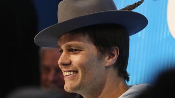 Tom Brady sports a different kind of headgear during Monday night's media session in Minneapolis.