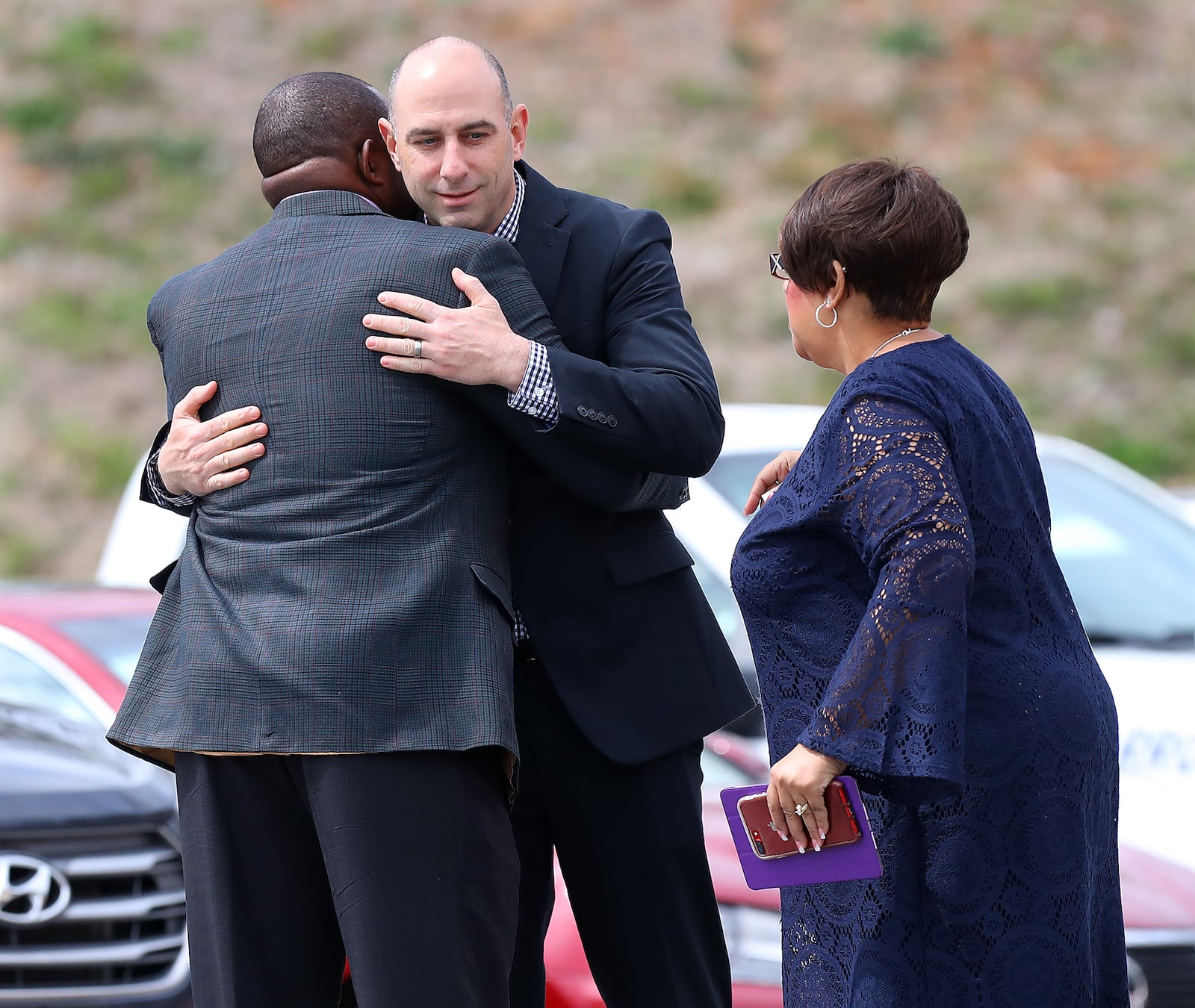 People share hugs as local residents, family, friends and church members arrive for the Tripp Halstead memorial service at the Jefferson Civic Center on Sunday, March 18, 2018, in Jefferson. The 7-year-old died Thursday following a traumatic brain injury five years ago from a falling tree limb. Photo by Curtis Compton/ccompton@ajc.com