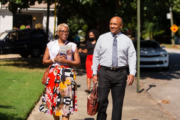 Tanya Joseph (left) and Herb Joseph (right), Jehovah's Witnesses, go door-to-door, in Atlanta's Old Fourth Ward.  The group resumed their door-to-door ministry after pausing for two-and-a-half-years due to the coronavirus pandemic. CHRISTINA MATACOTTA FOR THE ATLANTA JOURNAL-CONSTITUTION.