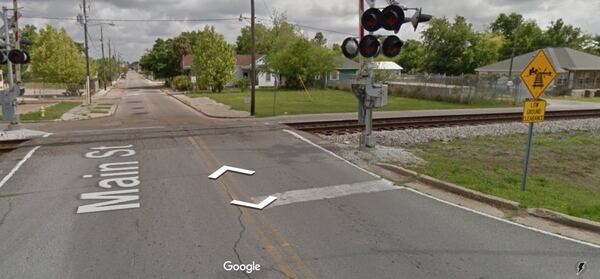 A Google street view of the railroad crossing in Biloxi, Miss., on Main Street at Esters Boulevard. The "low ground clearance" sign is on the right.