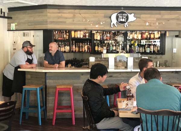 Curious Pig bar manager Michael DeReimer (right) stands with owner Scott Smith. After working the bar scene for 15 years, DeReimer praises the quality of life at the gastropub. LIGAYA FIGUERAS / LFIGUERAS@AJC.COM