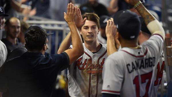 Pitcher Max Fried is congratulated by Braves teammates after scoring as a pinch runner on a double by Ender Inciarte during the 10th inning Sunday, May 5, 2019,in Miami.