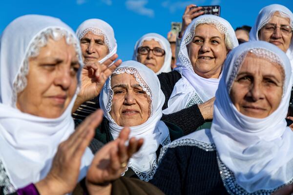 FILE - Kurdish women gather to watch live on a tv screen a Pro-Kurdish Peoples' Equality and Democracy Party, or DEM, delegation members releasing an statement from the jailed leader of the rebel Kurdistan Workers' Party, or PKK, Abdullah Ocalan, in Diyarbakir, Turkey, Thursday, Feb. 27, 2025. (AP Photo/Metin Yoksu, File)