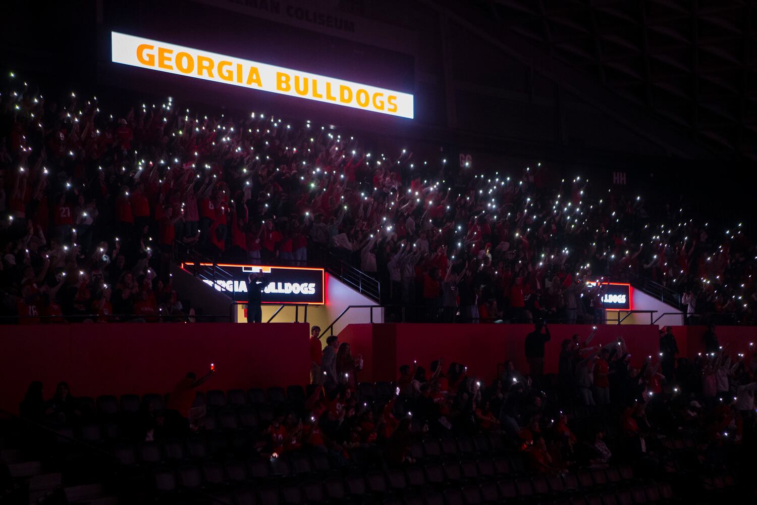 University of Georgia fans light up Stegeman Coliseum during the fourth quarter of the College Football Championship on Monday, January 9, 2023, at Stegeman Coliseum in Athens, Georgia. The University of Georgia defeated the Texas Christian University football team 65-7. CHRISTINA MATACOTTA FOR THE ATLANTA JOURNAL-CONSTITUTION.