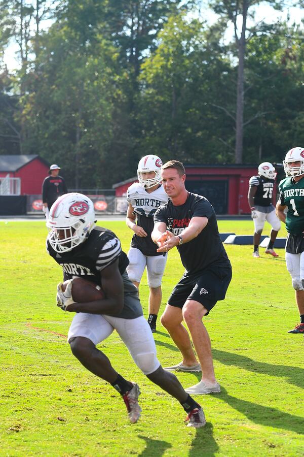 SUWANEE, GA - SEPTEMBER 11:  Atlanta Falcon Matt Ryan (C) and Campbell's Chunky Soup surprise high school football team during practice on September 11, 2018 in Suwanee, Georgia.  (Photo by Marcus Ingram/Getty Images for Campbell's Chunky Soup)