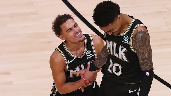 Hawks guard Trae Young celebrates with forward John Collins after he hit a three-pointer adding to Atlanta's second-half lead against the New York Knicks during Game 4 of their first-round NBA playoff matchup Sunday, May 30, 2021, at State Farm Arena in Atlanta. The Hawks beat the Knicks 113-96. (Curtis Compton / Curtis.Compton@ajc.com)