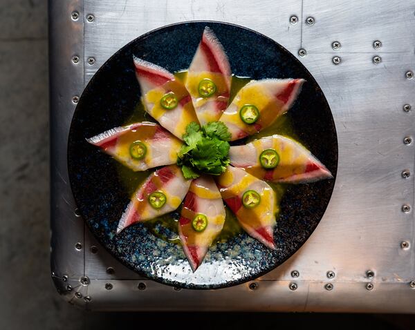 Does the smoked hamachi carpaccio with jalapeno yuzu kosho sauce taste as good as it looks? Yes, says AJC dining critic Wendell Brock. CONTRIBUTED BY HENRI HOLLIS