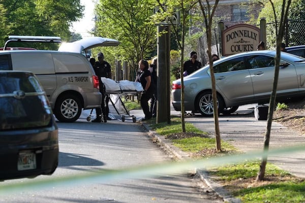 Investigators with the Fulton County Medical Examiner's Office removed the man's body from the wrecked vehicle Friday outside the Donnelly Courts apartments in southwest Atlanta.