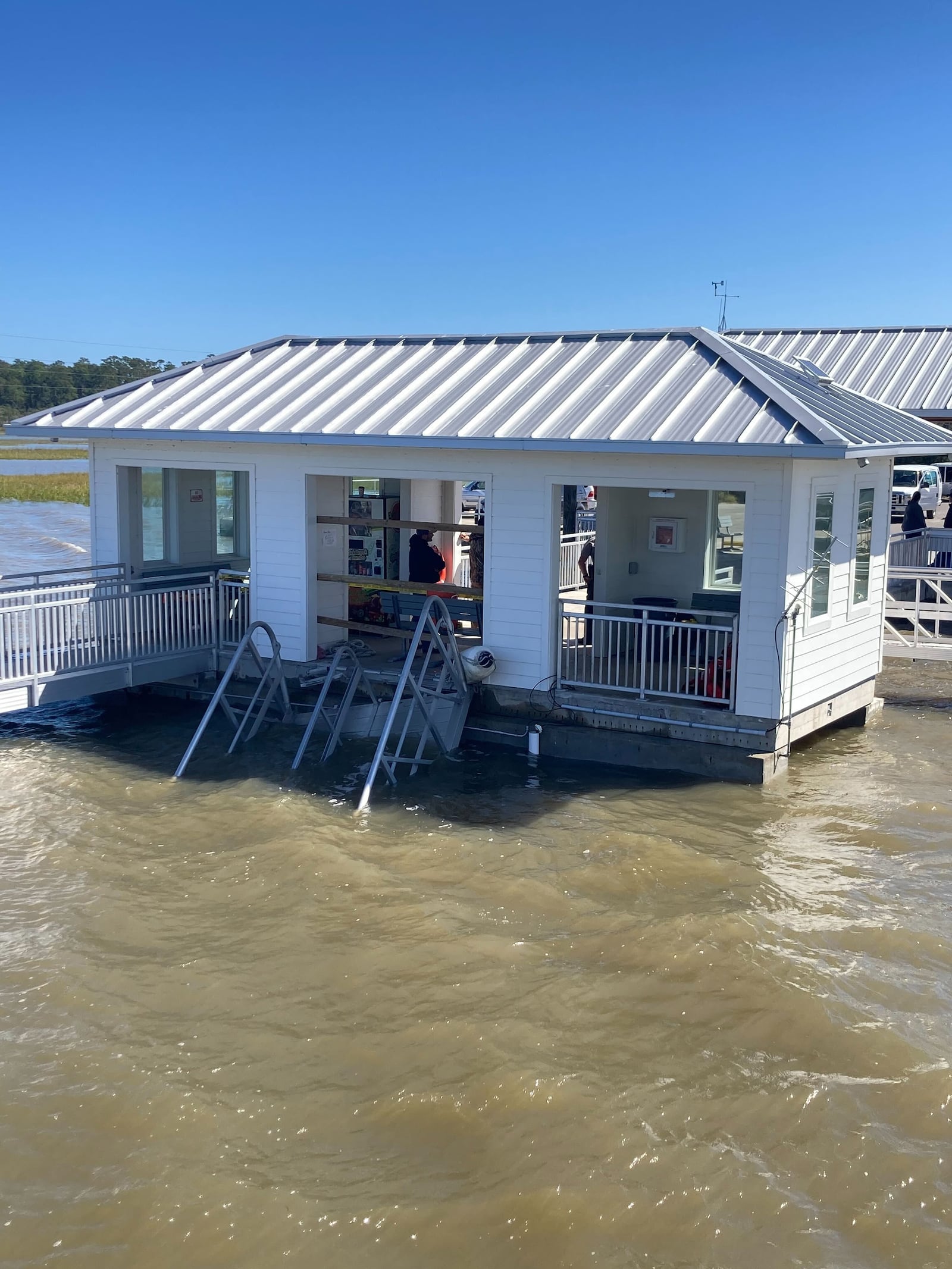 The ferry gangway can be seen partially in the water Sunday, Oct. 20, 2024. A celebration of Gullah Geechee descendants of Black slaves turned tragic when the gangway collapsed Saturday afternoon on Sapelo Island in Georgia. (Adam Van Brimmer/AJC)