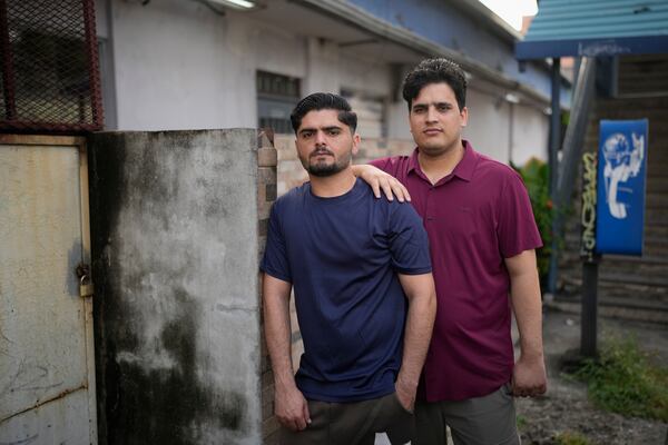 Samin Haider, left, a migrant from Pakistan, and his cousin Saqlain Sayed, pose for a portrait in Panama City, Monday, March 10, 2025, after being deported from the United States, detained for weeks in a Panamanian immigration camp, and released on a temporary humanitarian visa allowing a 30‑day stay. (AP Photo/Matias Delacroix)