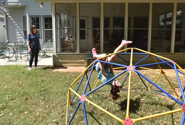 September 24, 2019 Marietta - Kelly Hobby watches as her 8-year-old daughter Chloé playing in their backyard in Marietta on Tuesday, September 24, 2019. The Marietta City Schools System in January will begin an initiative providing free child care for its employees. Kelly Hobby, a teacher at Al Burruss Elementary School in Marietta, is an educator who has signed up for the school system's initiative to provide free child care for its employees. Currently, Hobby said she has to rely on friends to watch her daughter when she has to work on professional development days. (Hyosub Shin / Hyosub.Shin@ajc.com)