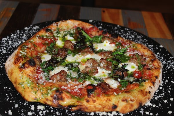 Fennel sausage, rapini, pesto, and Calabrian chili pizza.