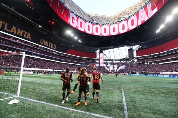 Miguel Almiron jumps on Josef Martinez’s back to celebrate Martinez’s goal for a 1-0 lead against Philadelphia Union Saturday, June 2, 2018, at Mercedes-Benz Stadium in Atlanta.  