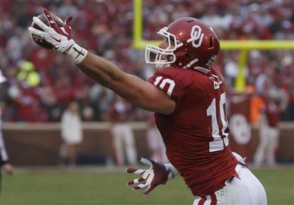 Oklahoma tight end Blake Bell (10) grabs a pass in the second quarter of an NCAA college football game against Oklahoma State in Norman, Okla. Improving the chances of being a pro football player was motivation enough to switch from throwing passes to catching them. Oklahoma's Blake Bell switched from quarterback to tight end as a senior. (Associated Press)