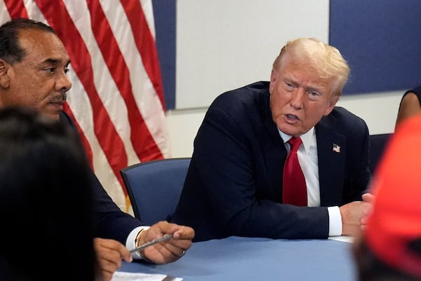 FILE - Republican presidential candidate former President Donald Trump, right, speaks during a roundtable discussion with local Black business leaders in Atlanta, Aug. 3, 2024. (AP Photo/John Bazemore, File)