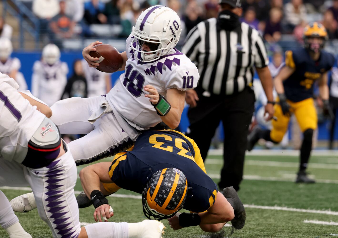 Trinity Christian quarterback David Dallas (10) is tackled by Prince Avenue Christian linebacker Davis Ridings (33) in the first half of the Class 1A Private championship at Center Parc Stadium Monday, December 28, 2020 in Atlanta, Ga.. JASON GETZ FOR THE ATLANTA JOURNAL-CONSTITUTION