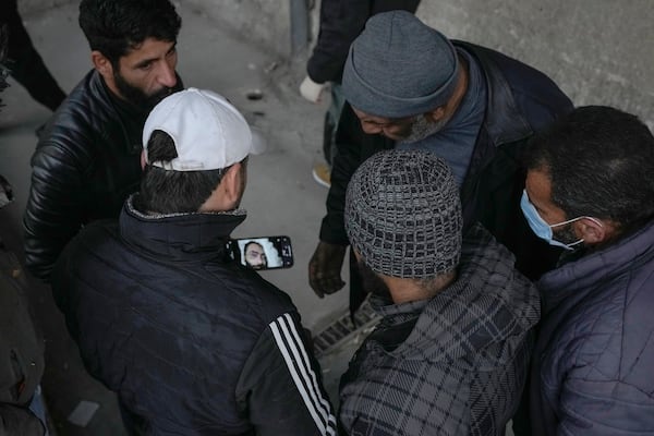 A man shows a photo of a missing loved one as he searches the Al-Mojtahed hospital morgue in Damascus, Syria, on Wednesday, Dec. 11, 2024. Many are flocking to morgues, hoping to identify loved ones who were either killed or imprisoned under President Bashar Assad's government, which collapsed over the weekend. (AP Photo/Hussein Malla)