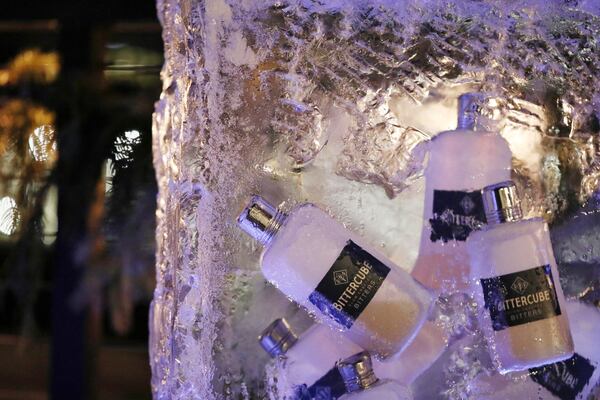 Bottles of bittercube corazon bitters sit suspended in a block of ice, which patrons must use an ice pick to free when ordering the yukon cornelius on Hewing Hotel's rooftop on Dec. 22, 2017 in Minneapolis. (Anthony Souffle/Minneapolis Star Tribune/TNS)